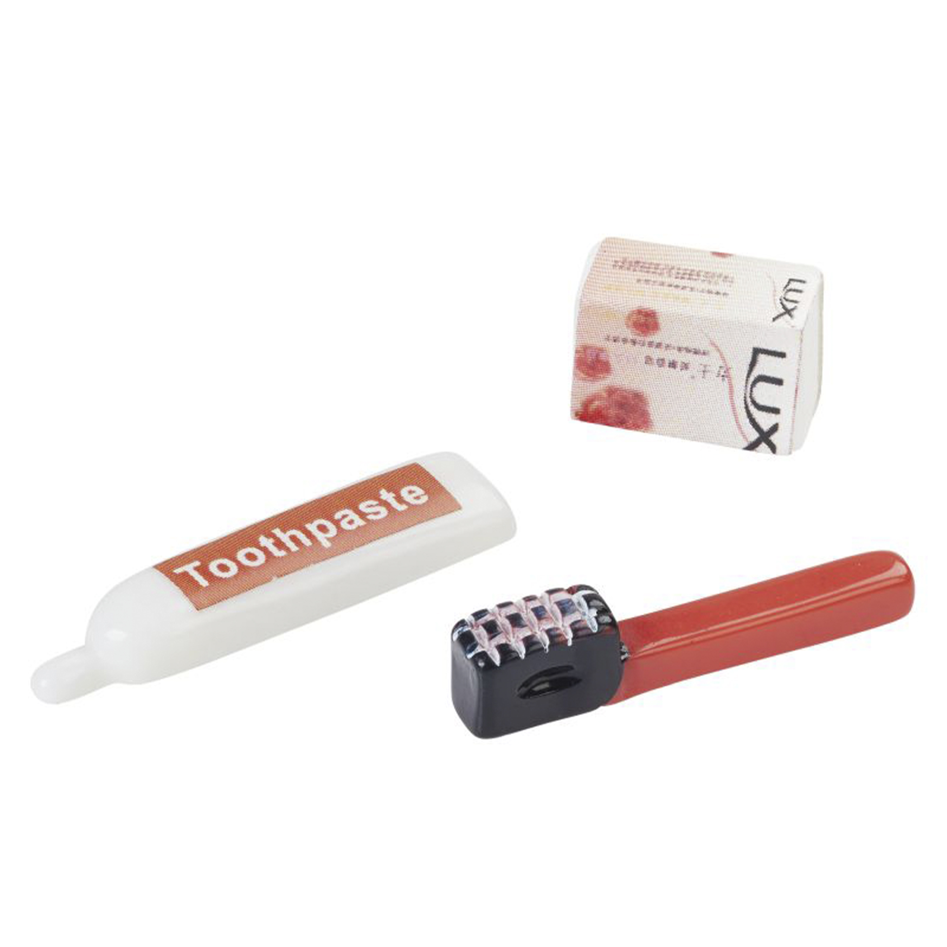 rote Zahnbürste mit dunklem Kopf, weiß-rote Tube und LUX-Seifenstück