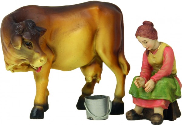 Bäuerin mit Kuh beim Melken 